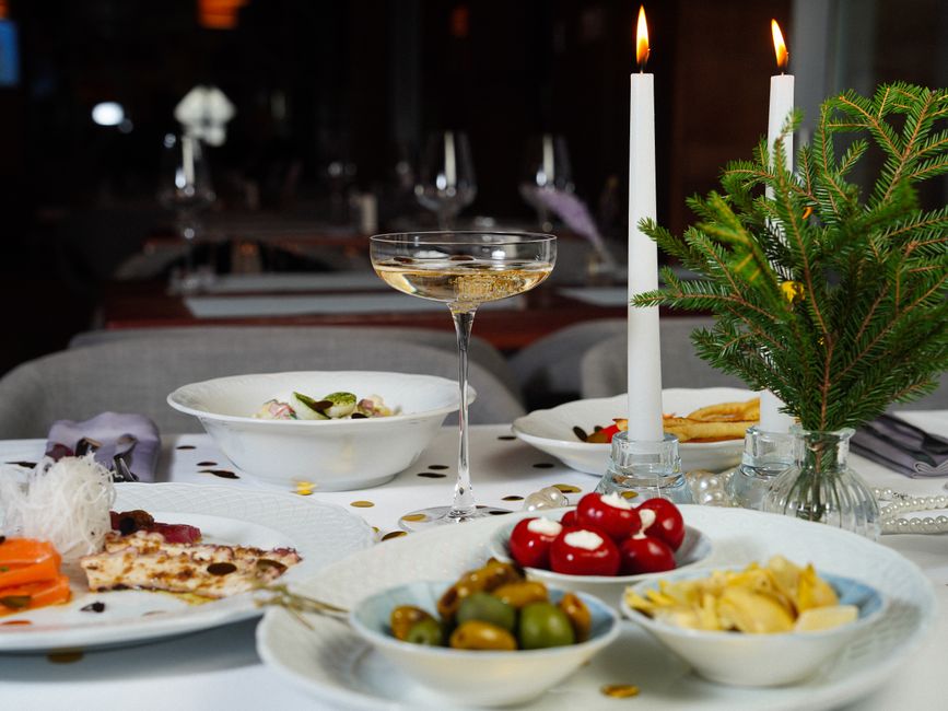 Festively set celebration table with candles and champagne glasses