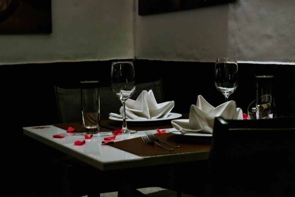 Intimate candlelit indoor dining table set for dinner